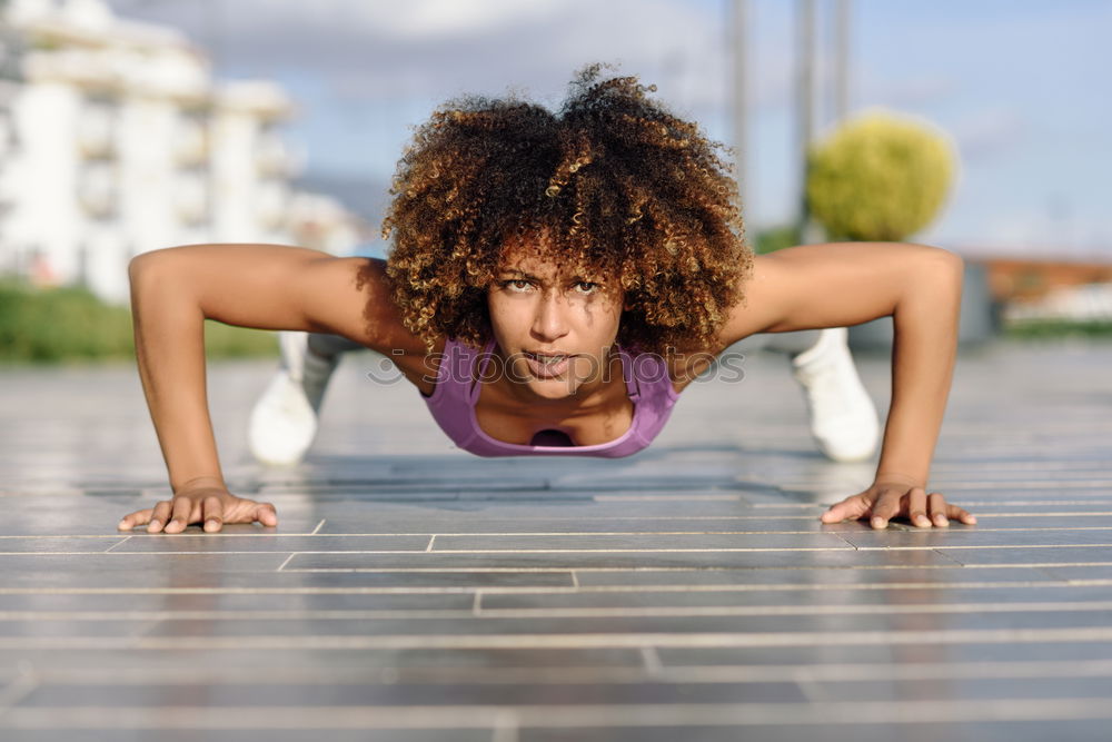 Similar – Black fit woman doing pushups on urban floor.