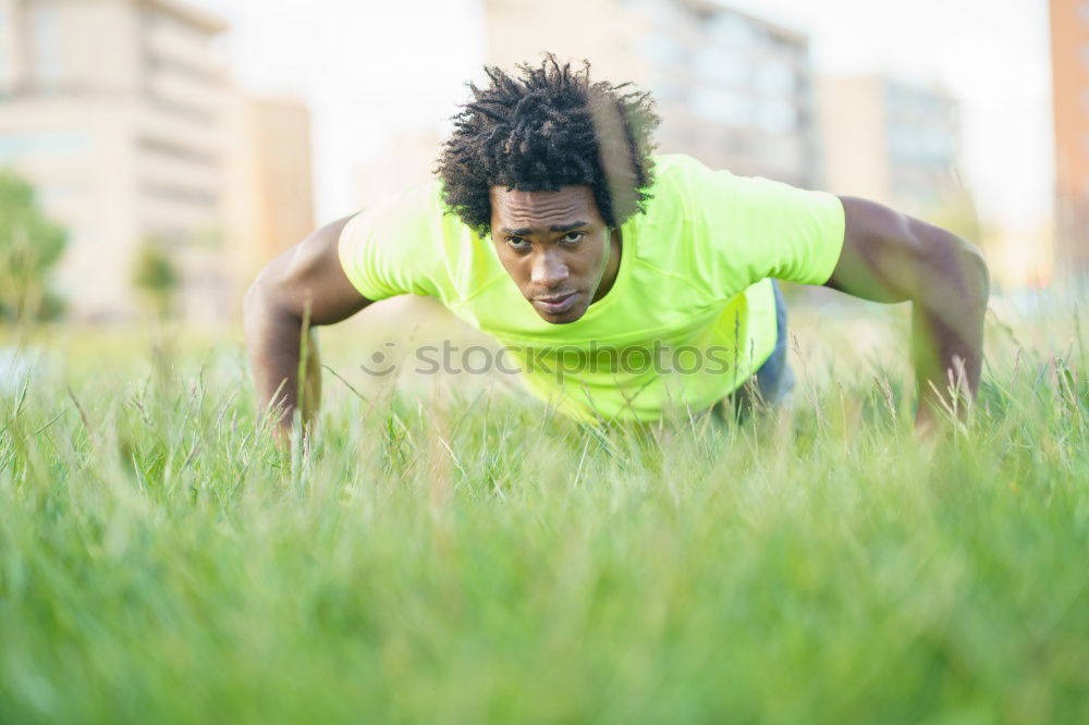 Similar – Black man doing stretching after running in urban background