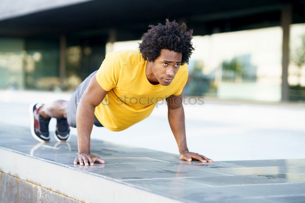 Similar – Black man doing stretching after running in urban background