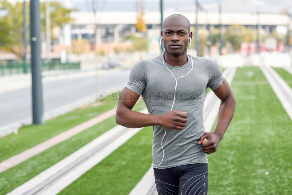 Similar – Black man running and listening to music in urban background