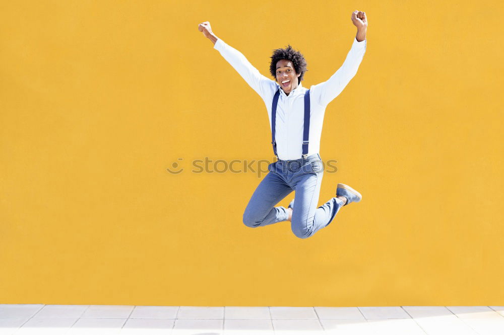 Black woman with afro hair celebrating with confetti.