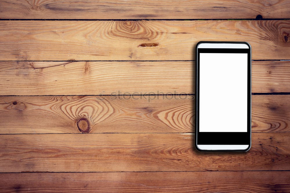 Similar – White Mobile Phone With Blank Screen On Wood Table