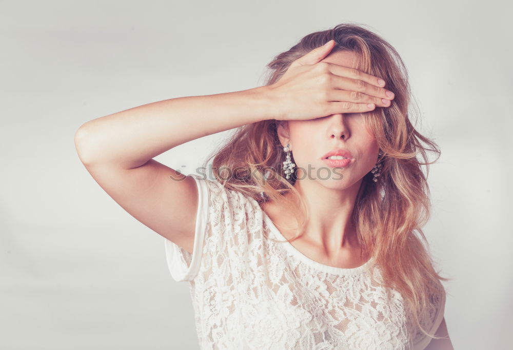 A blonde young woman in a sunny day thinking and feeling with closed eyes