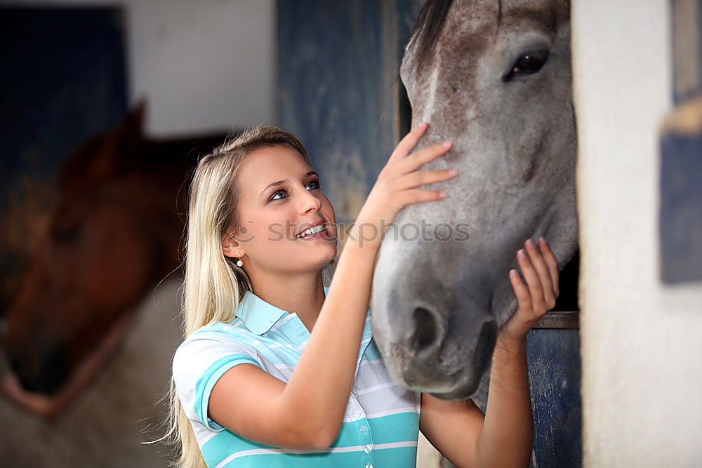 Similar – Young dark-haired curly woman with horse in stable