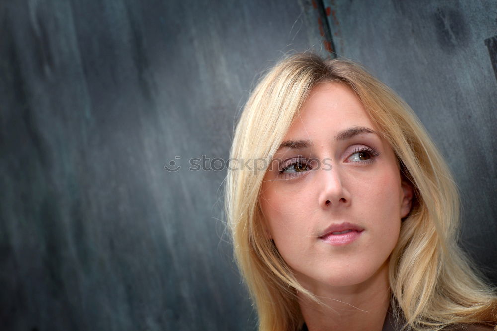 Elegant woman standing against dark background