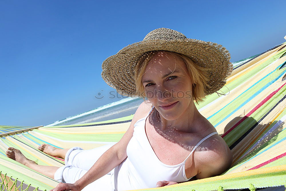 Similar – Image, Stock Photo Elderly woman on the beach wearing a straw hat