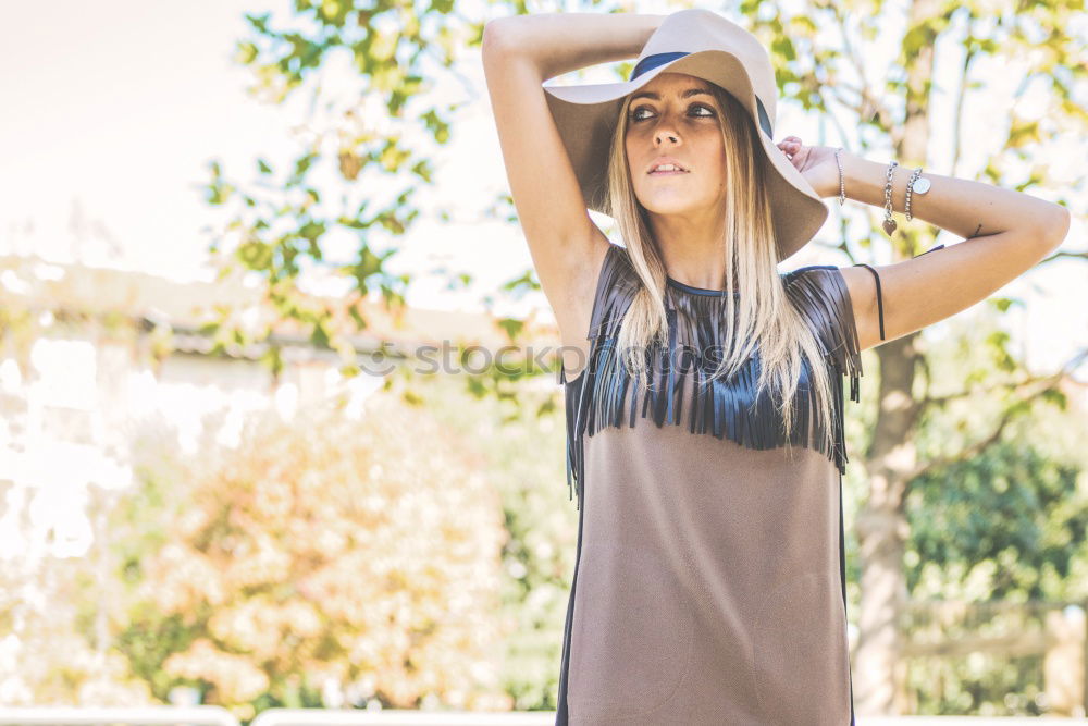 Similar – Image, Stock Photo Smiling blond woman with hat in urban background