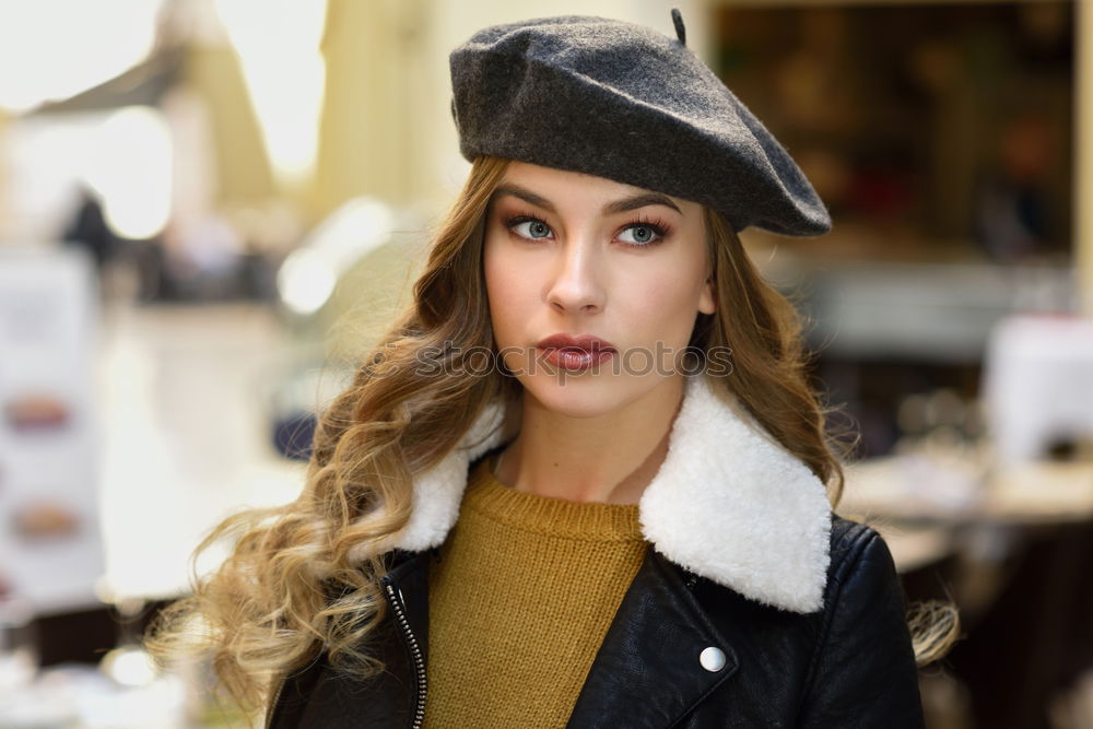 Beautiful young girl wearing beret standing in the street.