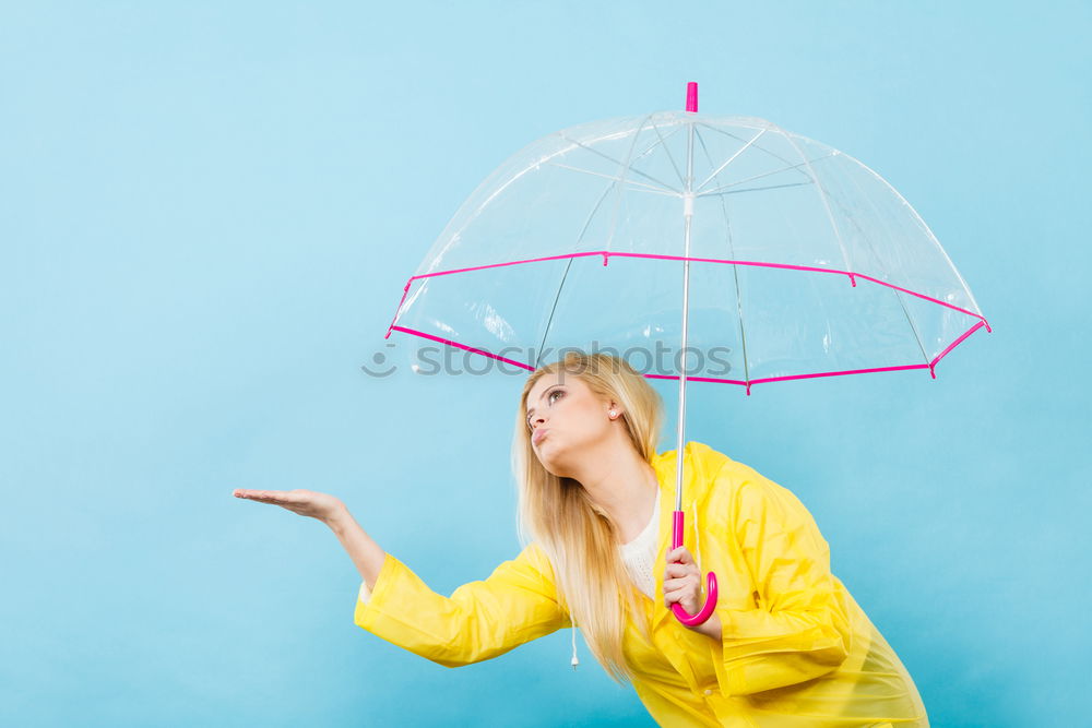 Similar – Woman with umbrella in front of green wall