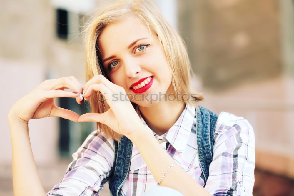 Similar – Smiling blonde girl with red shirt enjoying life outdoors.