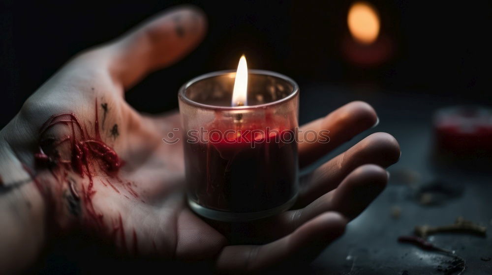 Similar – A single red burning candle held by a girl