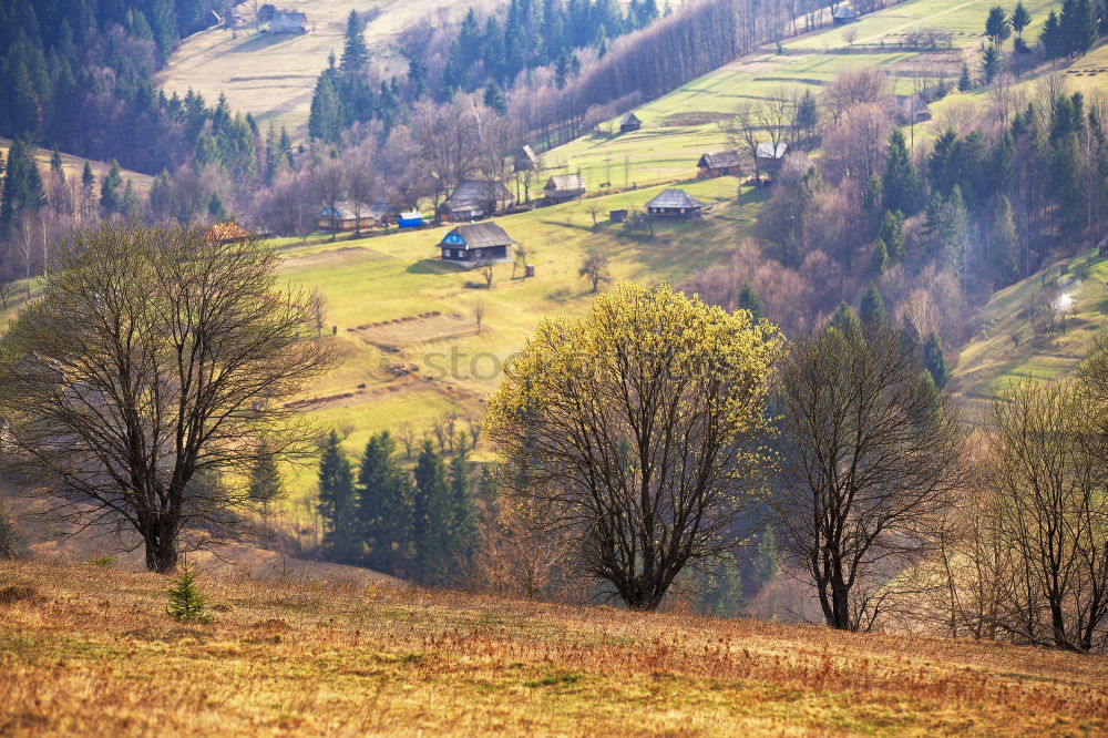 Similar – Mountains village on hillsides. Lone house on green hills