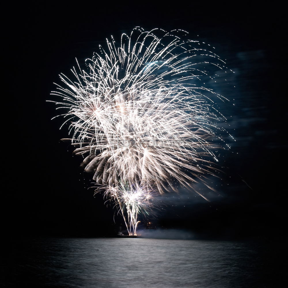 Similar – Colorful fireworks with water reflection