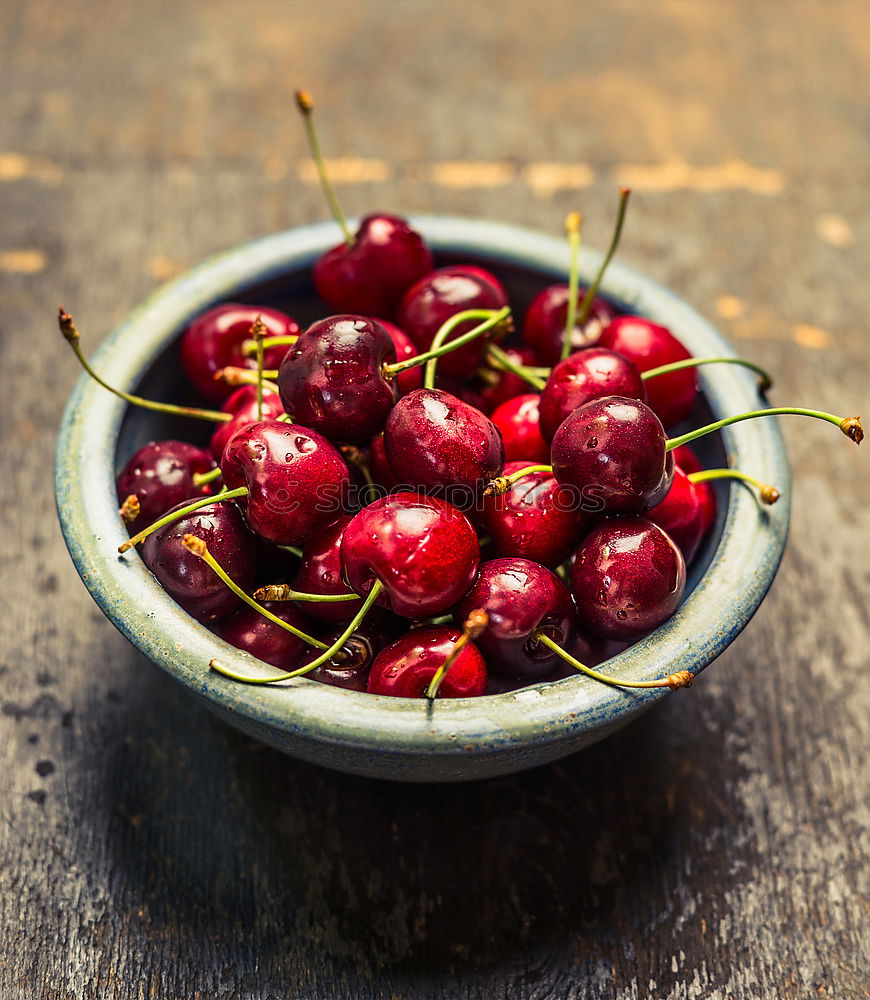 Similar – Sweet cherries in a blue bowl on a dark wooden table