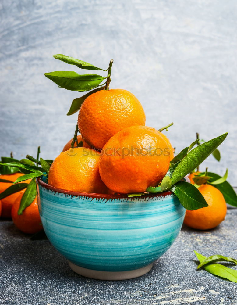 Similar – Image, Stock Photo Tangerines with green leaves in the blue bowl