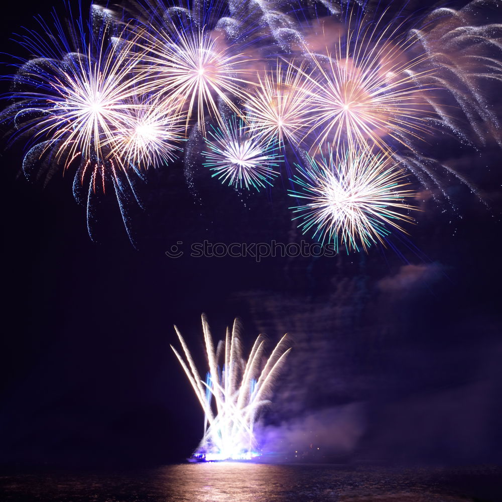 Similar – Colorful fireworks with water reflection