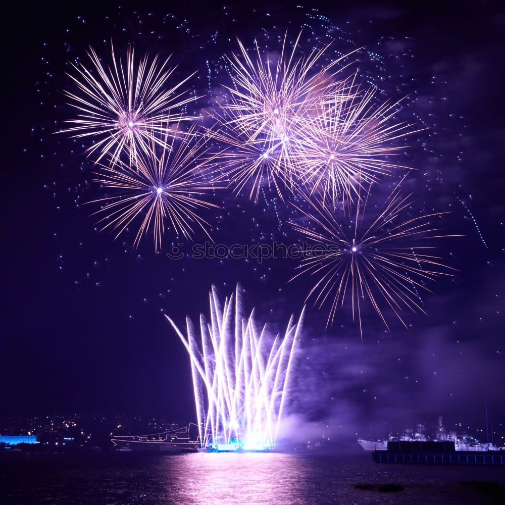 Blue colorful fireworks with water reflection