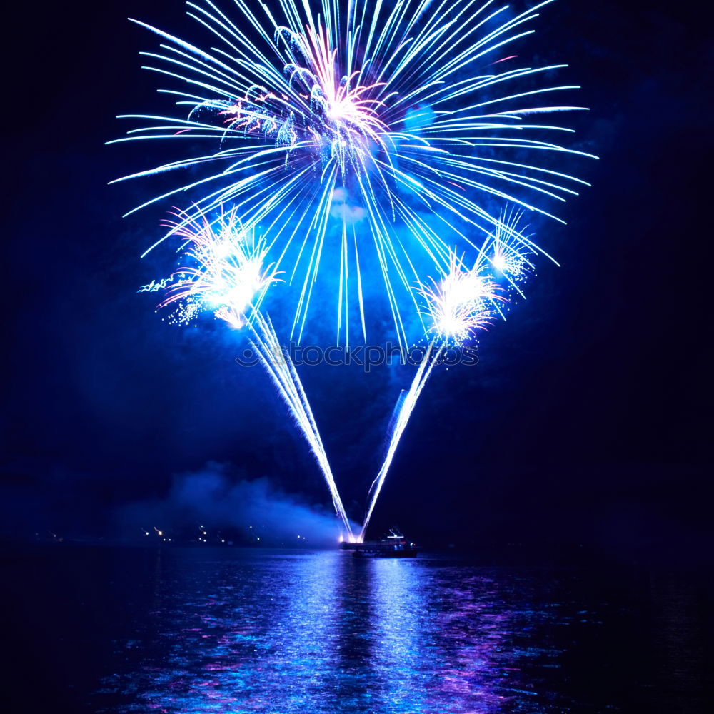 Similar – Colorful fireworks above a lake