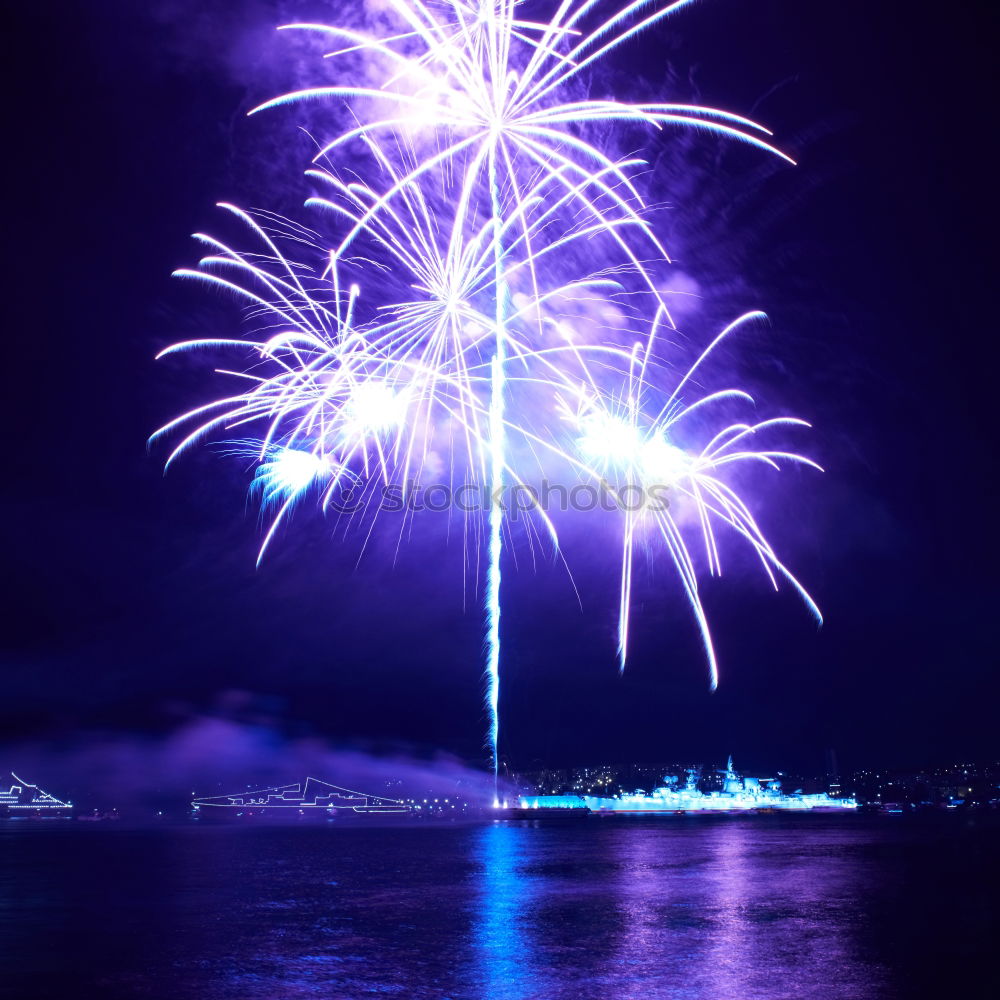 Similar – Blue colorful fireworks with water reflection