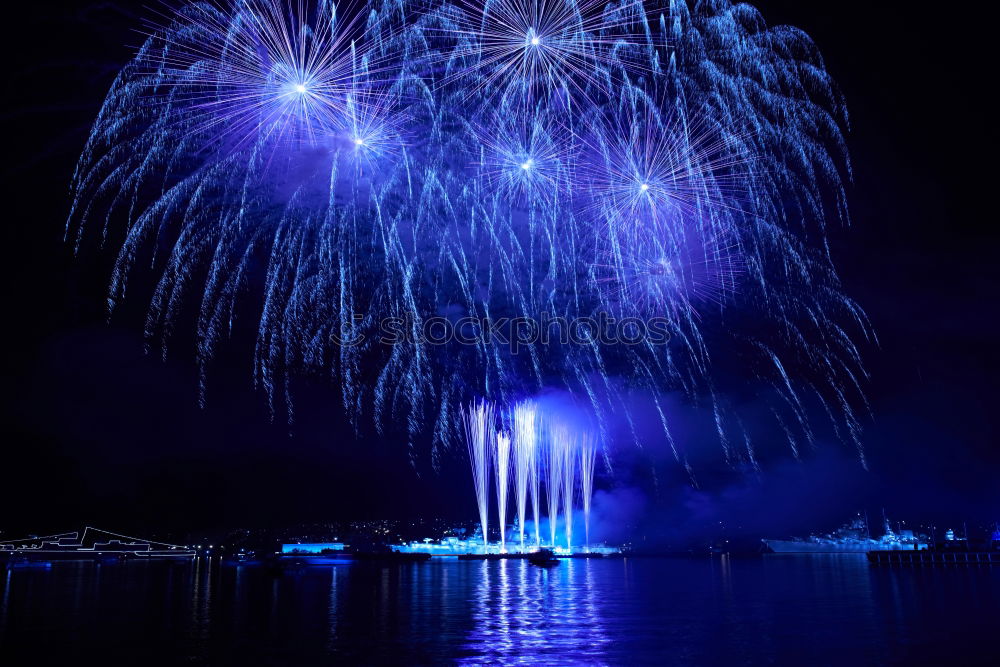 Similar – Blue colorful fireworks with water reflection