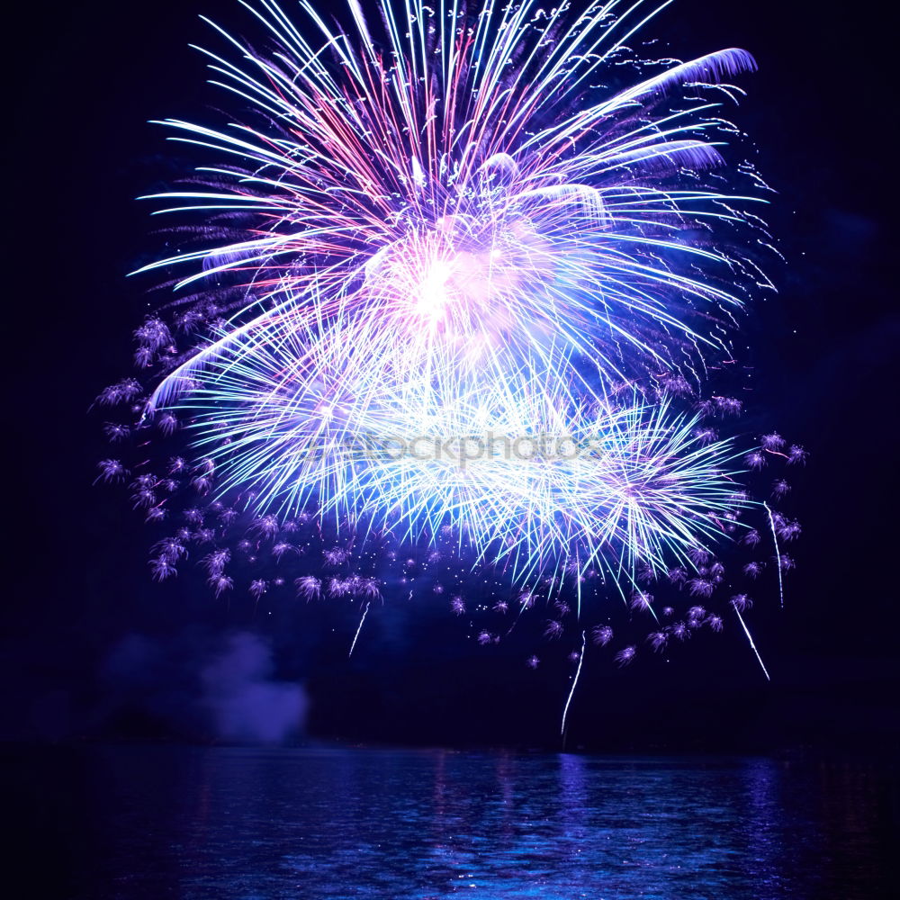 Similar – Colorful fireworks above a lake