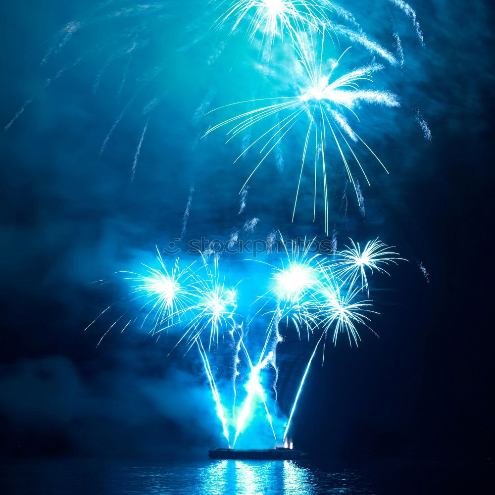 Similar – Colorful fireworks above a lake