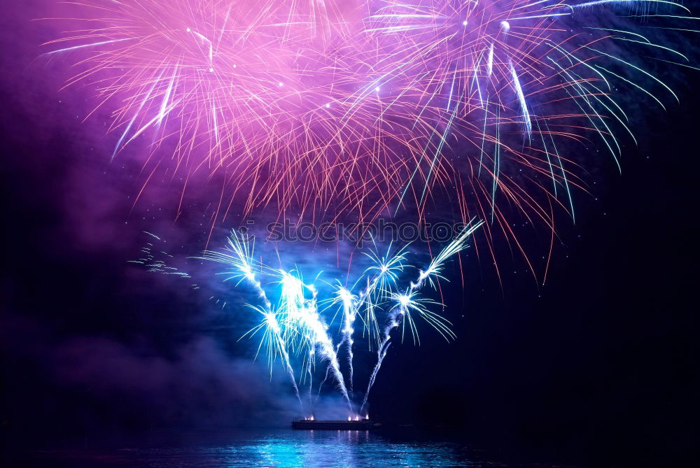 Similar – Blue colorful fireworks with water reflection