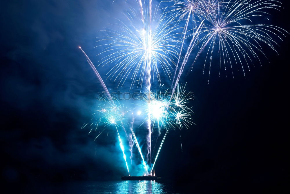 Similar – Colorful fireworks above a lake