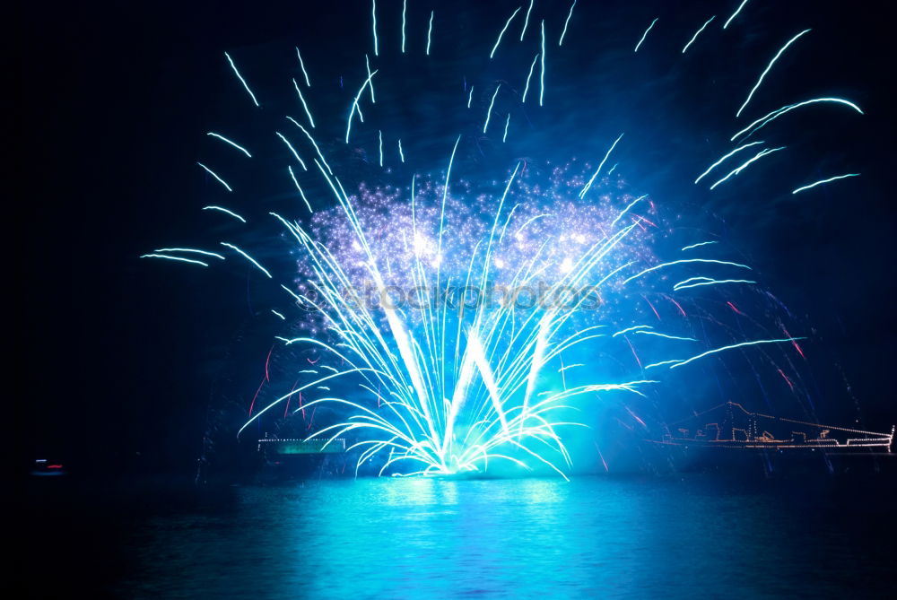 Similar – Blue colorful fireworks with water reflection