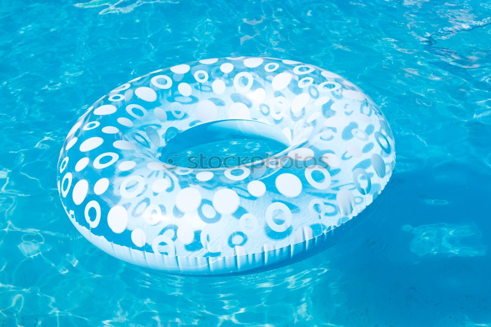 Similar – Image, Stock Photo yellow inflatable donuts floating in a swimming pool. Nobody. Summer time concept