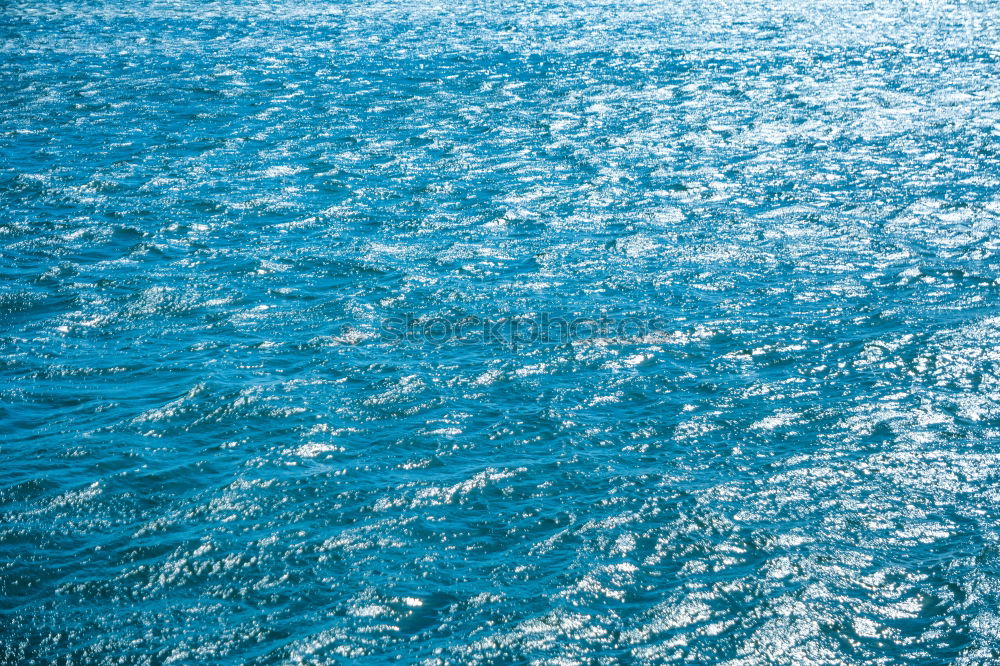 Similar – Blue water with sun line