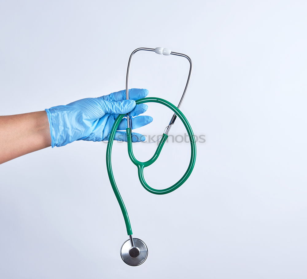 human hand holding a medical stethoscope