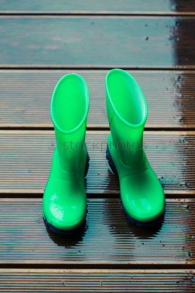 Similar – Kid standing on a porch wearing green wellies and raincoat