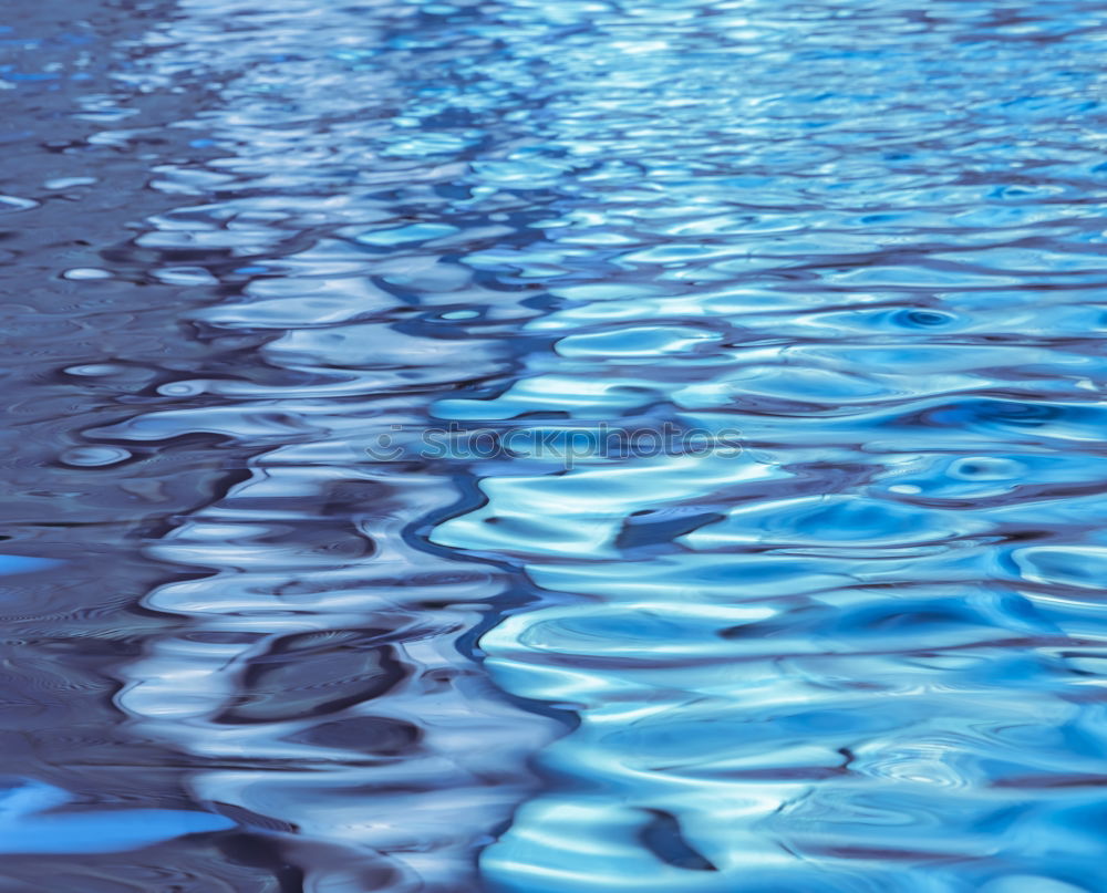 Rainwater on a blue garden table with reflection