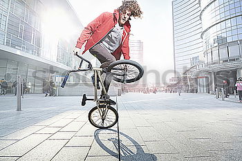 Similar – Image, Stock Photo Handsome young man on bike in the city.