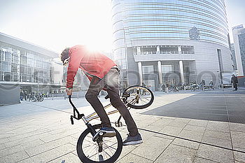 Similar – Image, Stock Photo Handsome young man on bike in the city.