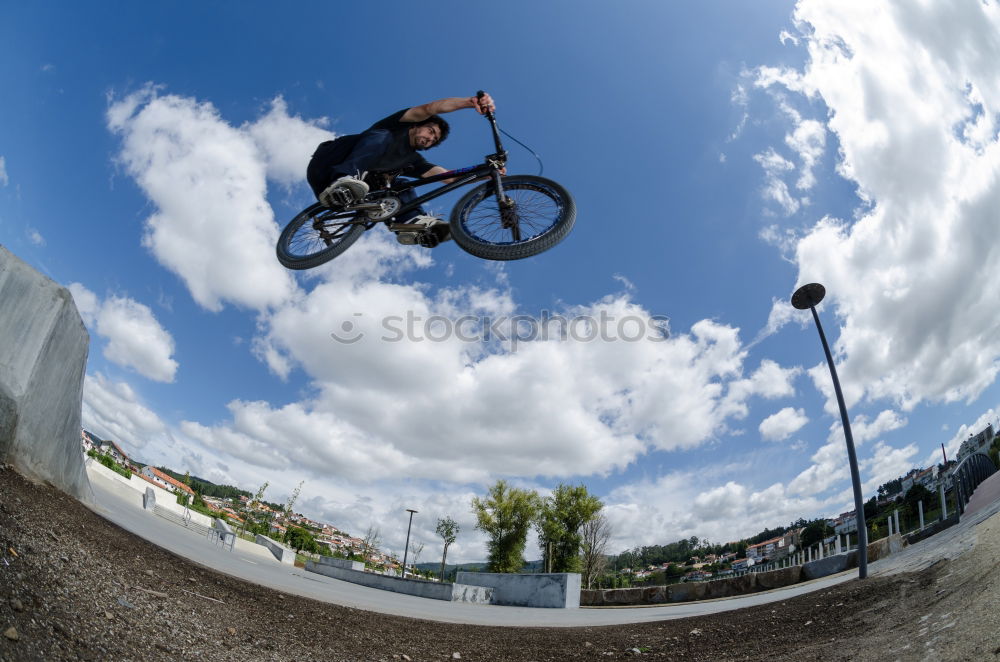 Similar – Girl on BMX bike in the air in halfpipe