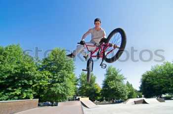 Similar – Girl on BMX bike in the air