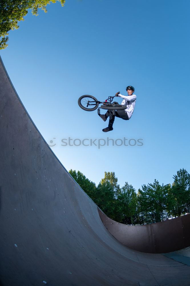 Similar – Girl on BMX bike in the air in halfpipe