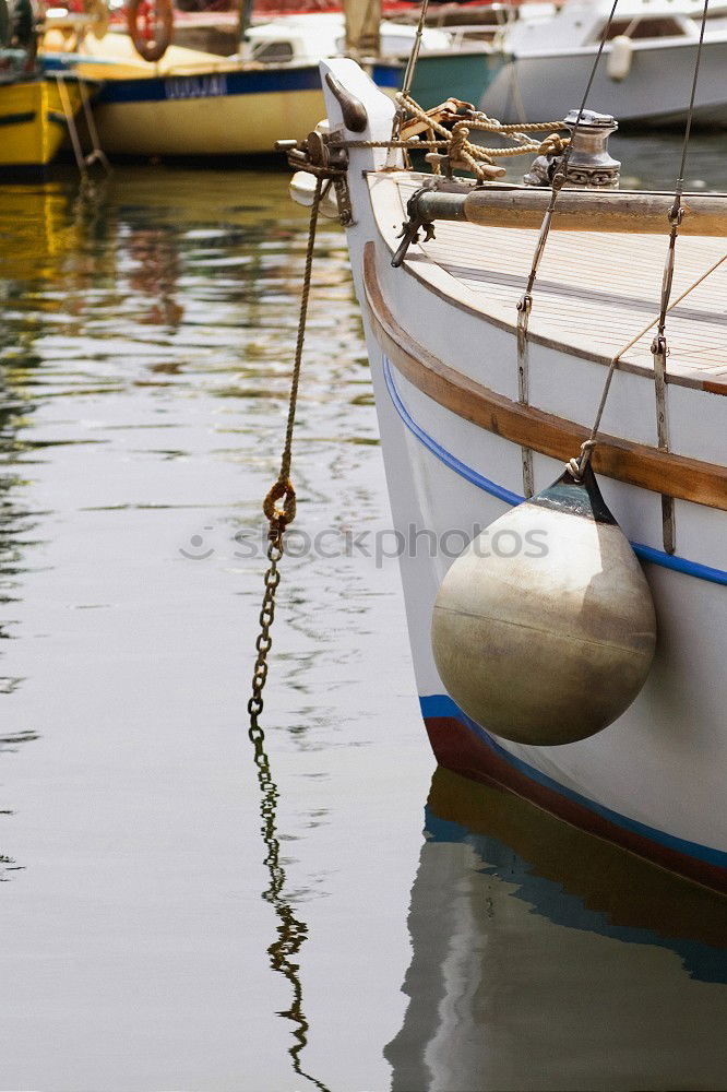 Similar – Fenders suspended between a boat and dockside for protection. Maritime fenders