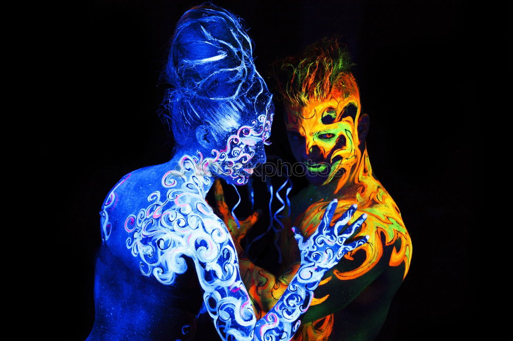 Similar – Couple with fluorescent paint kissing