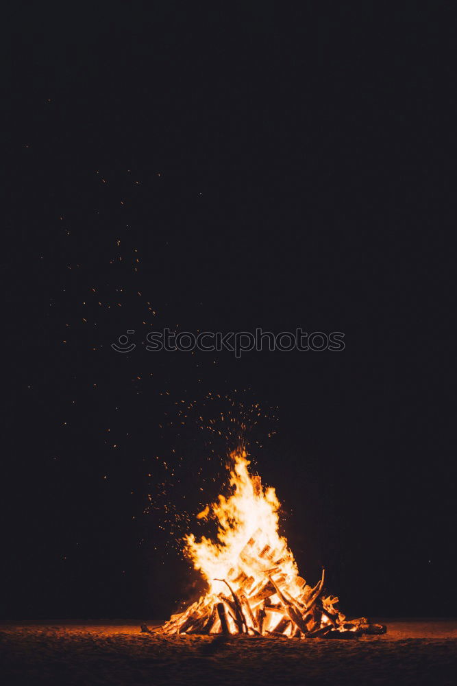 Similar – Image, Stock Photo Man lights a fire in the fireplace in nature at night