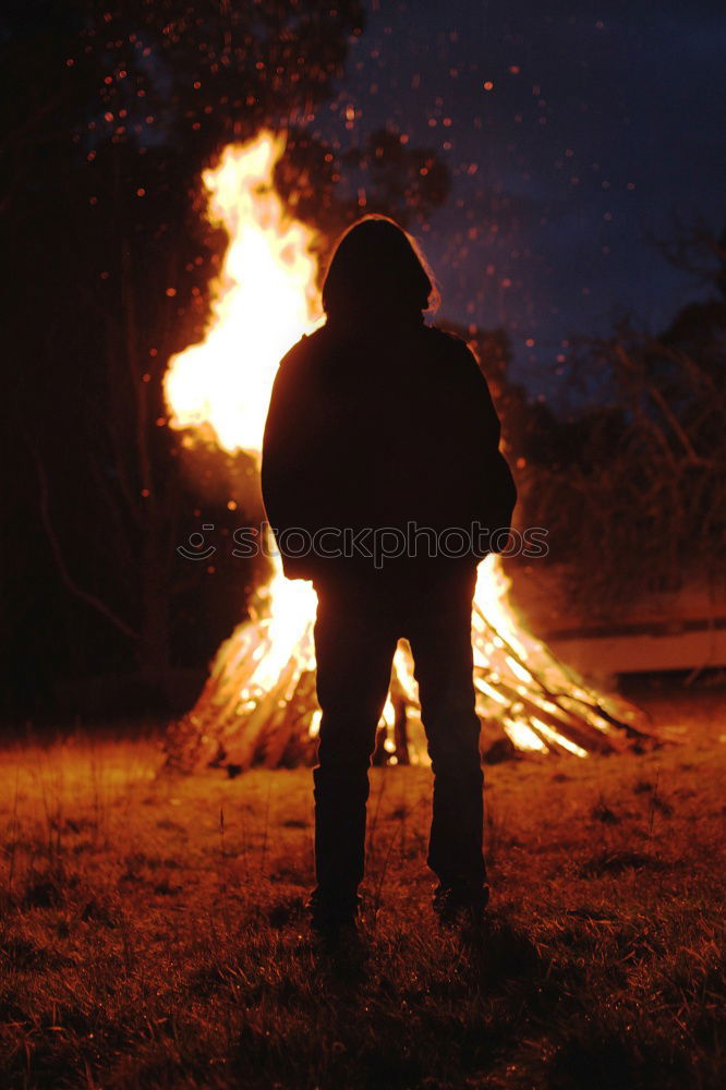 Similar – Man lights a fire in the fireplace