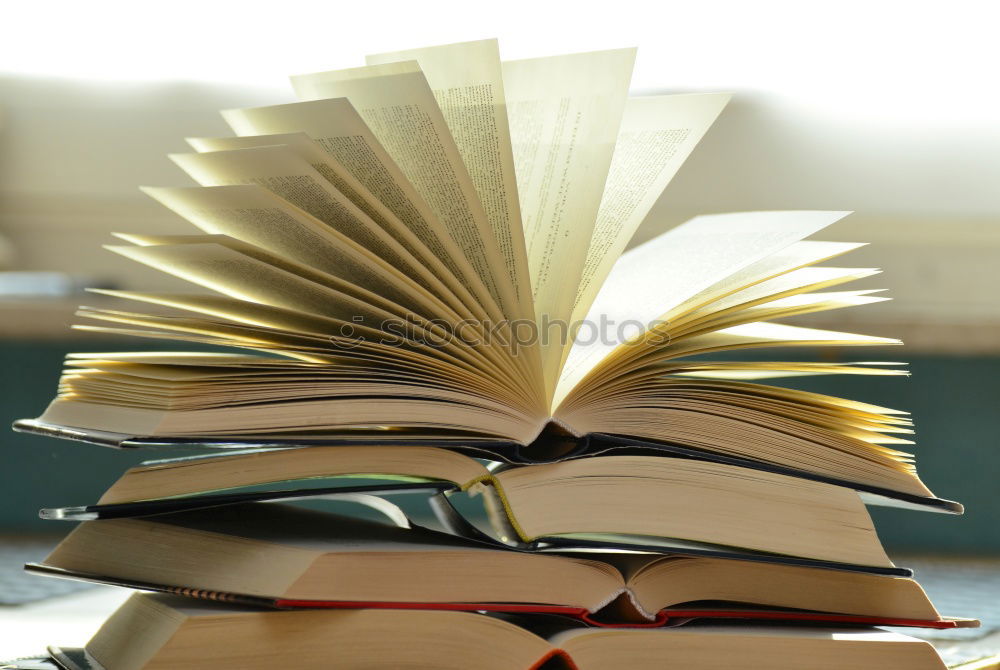 Similar – Woman turning pages of book on table in antique bookstore