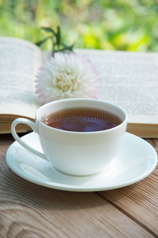 Similar – Black tea in a white cup and saucer and jasmine flowers