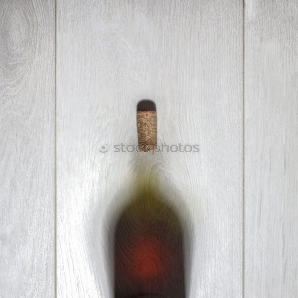 Breakfast is ready, said the alcoholic. Liquor bottle on a wooden table