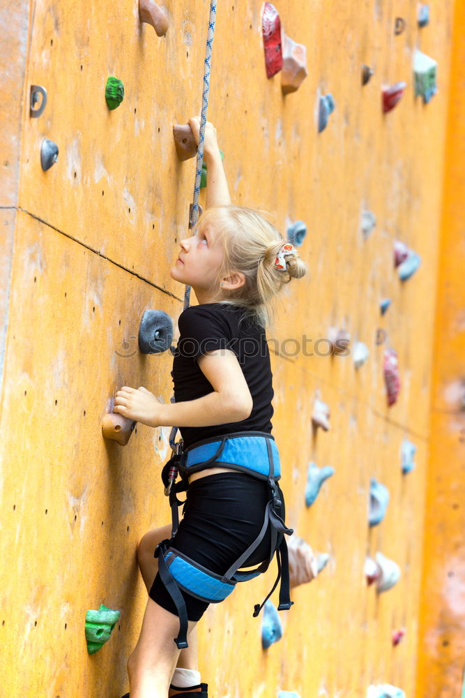 Similar – Image, Stock Photo little girl climbing a rock wall outdoor. Concept of sport life.