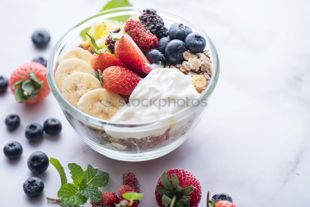 Acai bowl strawberry blueberry banana wooden table