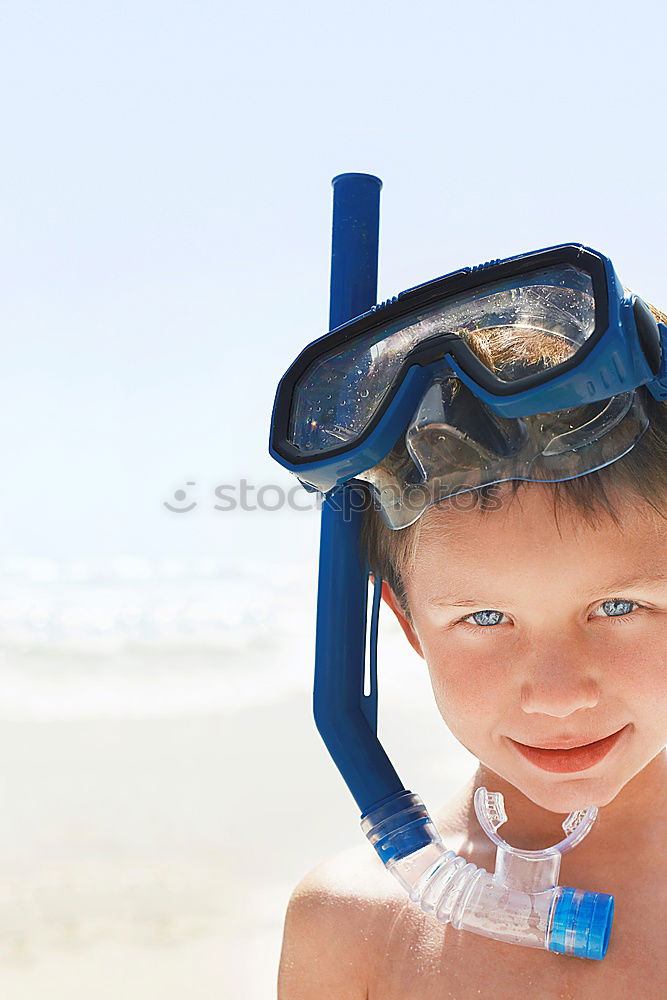 Kid in snorkel mask posing on poolside