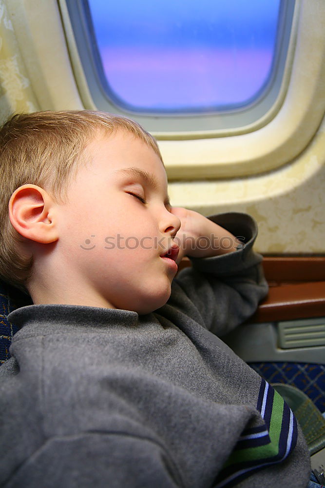 Similar – Image, Stock Photo Little boy sitting in his seat during a flight and painting on a tablet computer in an airplane